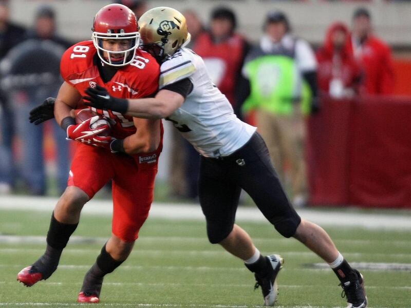 Utah Utes tight end Kendrick Moeai (81) gets tackled by Colorado Buffaloes linebacker Patrick Mahnke (12) during the fourth quarter of the Utah vs. Colorado football game at the Rice-Eccles Stadium in Salt Lake City on Friday, Nov. 25, 2011.