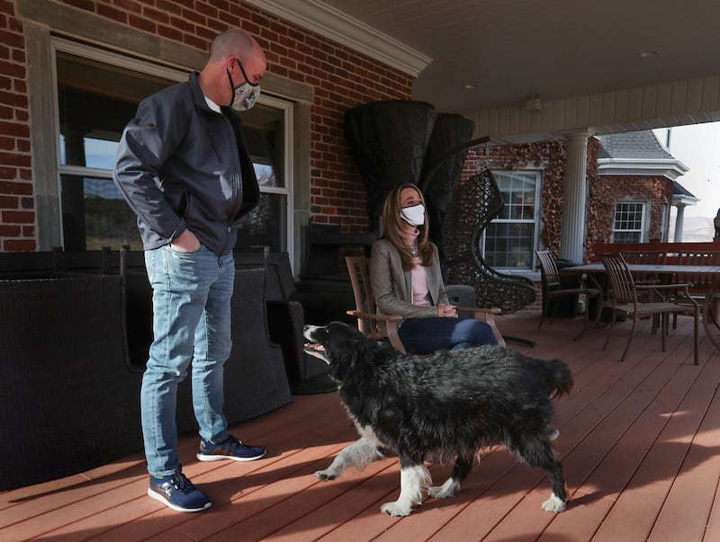 Spencer Cox stands with his wife and dog on their porch in Sanpete County where they discuss his recent win as Utah governor. 