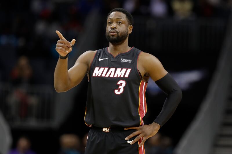 Miami Heat’s Dwyane Wade directs his team against the Charlotte Hornets.