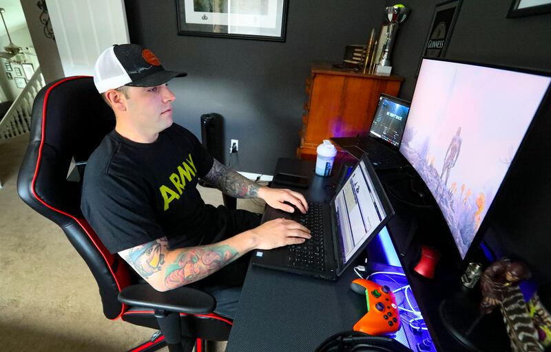 U.S. Army recruiter Staff Sgt. Garret Richard works on his laptop from his home in Pleasant Grove, Utah.