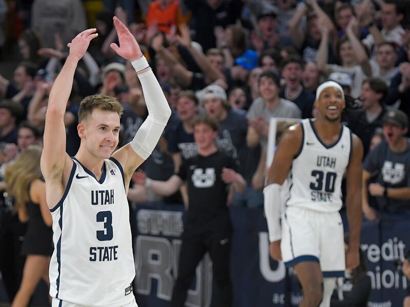 Utah State guard Steven Ashworth (3) and forward Dan Akin celebrate after defeating Boise State on Saturday, March 4, 2023, in Logan.