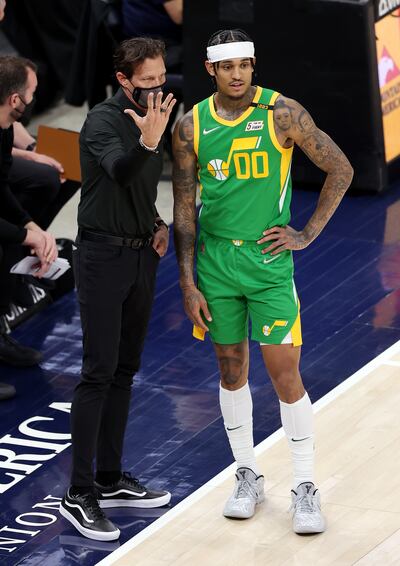 Utah Jazz coach Quin Snyder talks with Jordan Clarkson during a game against the Denver Nuggets at Vivint Arena in Salt Lake City.