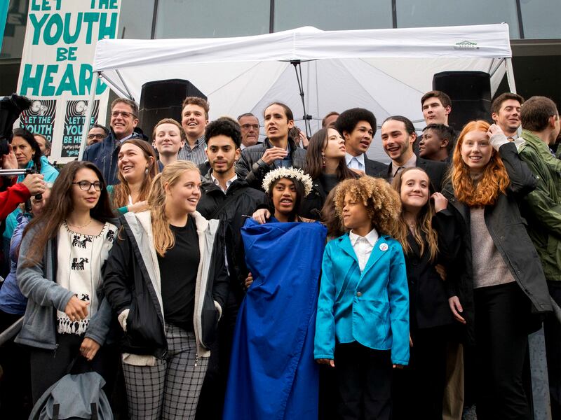 In this Oct. 29, 2018, file photo, young plaintiffs stand on the steps of the United States District Courthouse during a rally in Eugene, Ore., to support a high-profile climate change lawsuit against the federal government.