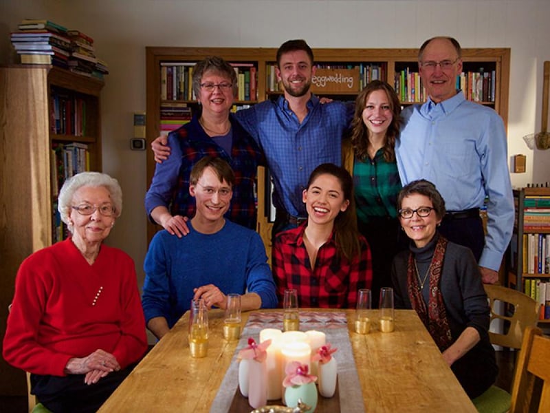 “Girl Meets Farm” host Molly Yeh, seated, with her husband and extended family. Yeh will be a keynote speaker at RootsTech March 3-5, 2022.