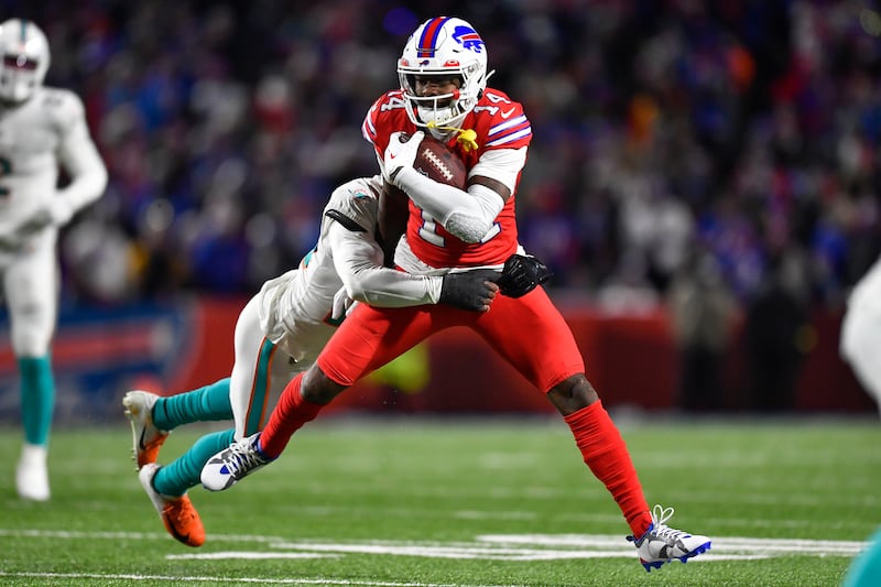 Buffalo Bills wide receiver Stefon Diggs is tackled by Miami Dolphins cornerback Kader Kohou during a game in Orchard Park, N.Y., Saturday, Dec. 17, 2022.