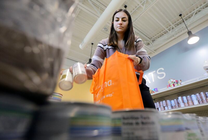 Volunteer Jordan Allen bags food for those in need at Catholic Community Services Basic Needs Ogden in Ogden, Utah.