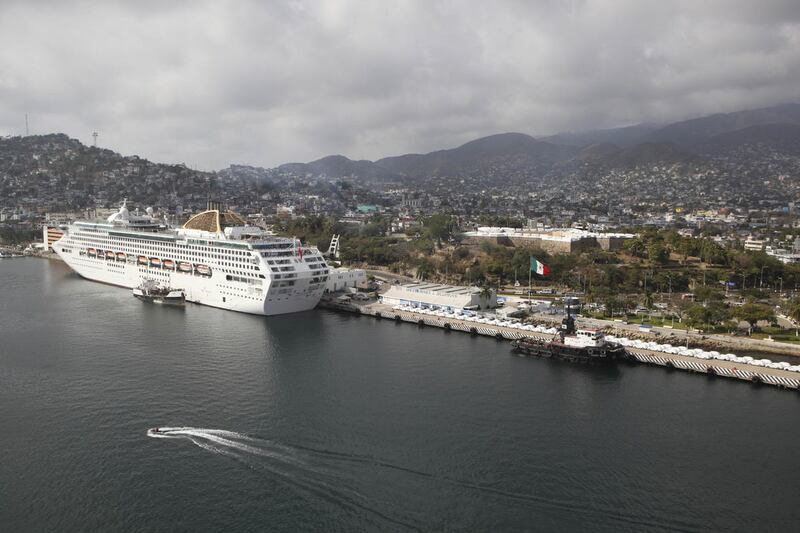 FILE — In this Jan. 16, 2011 file photo, a cruise ship is docked at the port in Acapulco, Mexico. The U.S. government on Friday, April 15, 2016 barred its employees from traveling to the Mexican resort city of Acapulco, where a rise in homicides attribute