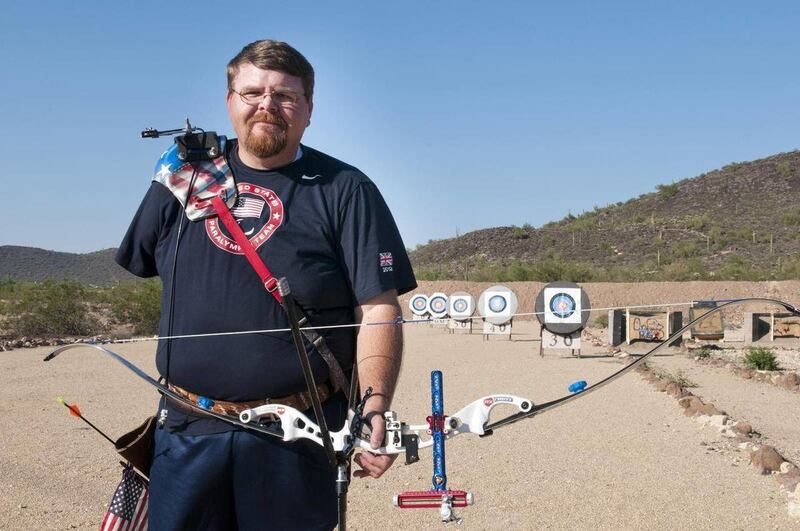 Eric Bennett, an high school engineering teacher, poses with his archery equipment in Surprise, Ariz., on Sept. 14, 2012. The engineering and physics teacher in the Dysart Unified School District placed fourth in the world in archery in the Men's Standing