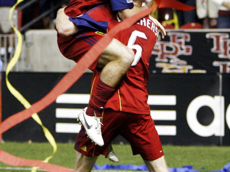 At top, Kyle Beckerman of RSL jumps on Nat Borchers to celebrate the goal Borchers made to tie the game. Real Salt Lake vs the Colorado Rapids MLS soccer played in Sandy on Sept. 25, 2010.