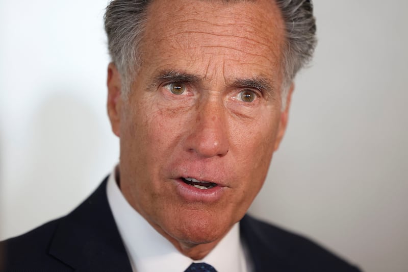 Sen. Mitt Romney speaks to reporters at the Larry H. Miller Company in Sandy.