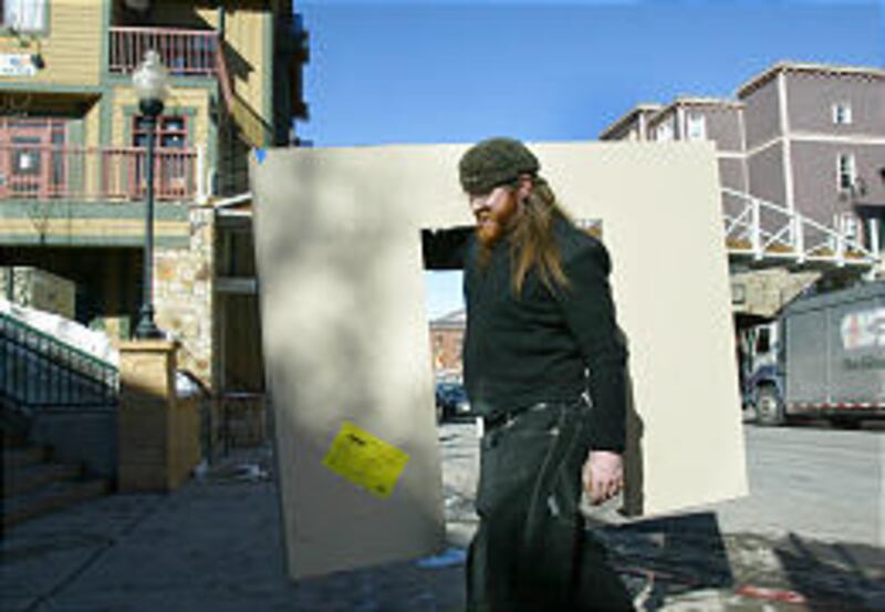 Reed Fanning carries part of a booth that will be set up in Park City for the Sundance Film Festival.