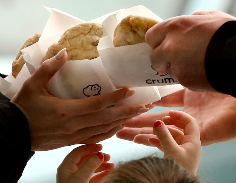 Family members grab a cookie after leaving Crumbl in Lehi on Friday, Dec. 21, 2018.