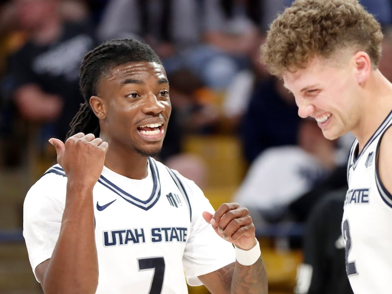 Utah State senior guard Kolby King (7) gets a laugh out of teammate Mason Falslev during Saturday's exhibition game against Seattle.