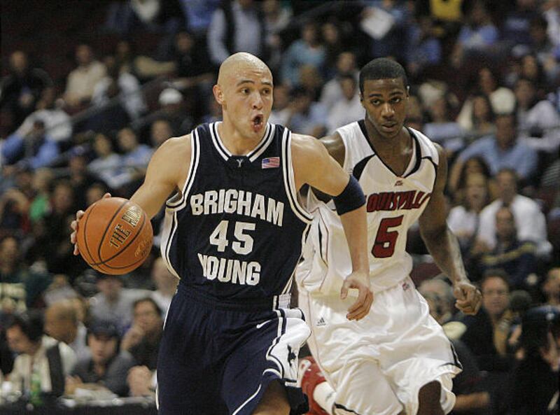 BYU's Jonathan Tavernari drives past Louisville's Earl Clark in Friday's game.