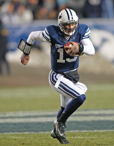 Brigham Young Cougars quarterback Riley Nelson (13) runs for a first down during first half action as BYU plays Idaho in the Cougar's final home football game on 2012  Saturday, Nov. 10, 2012,in Provo, Utah.