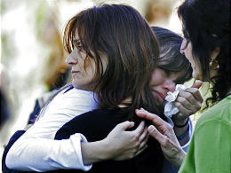 Mona Samaha, left, the mother of Reema Samaha, comforts a friend of her daughter during a convocation.