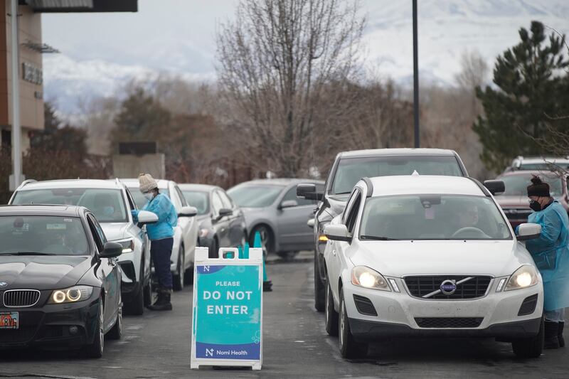 Medical workers test people for COVID-19 outside of the Draper Senior Center in Draper on Tuesday, Jan. 4, 2022.