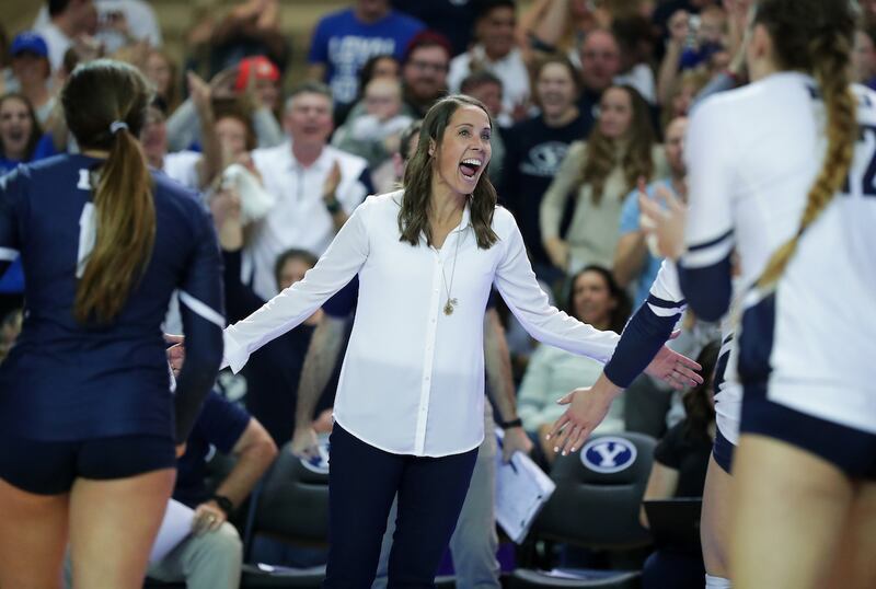 BYU head coach Heather Olmstead celebrates during a timeout in the third set of the Cougars' 3-0 sweep over Texas in the regional final of the NCAA women's volleyball championships on Saturday, Dec. 8, 2018 in Provo. On Thursday, Olmstead was named the AV