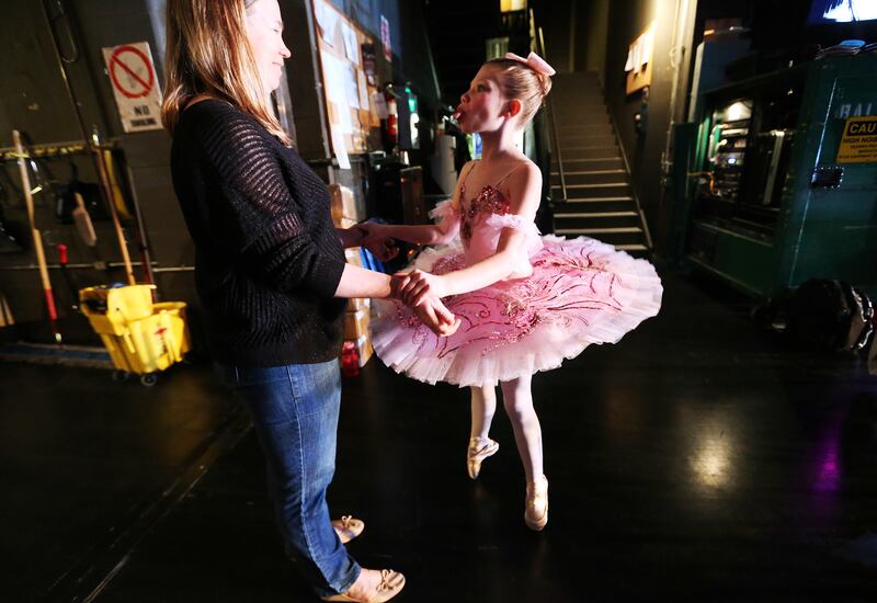 Serenity Blee, Grand Junction, Colorado, has some fun warming up with her mother Theresa as young ballet dancers audition for scholarships at the Capitol Theatre in Salt Lake City Sunday, Feb. 28, 2016. Hundreds of ballet dancers from across the nation au