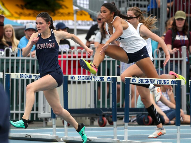Kayla Butterfield, of Herriman, left, competes in the 6A 100 meter hurdles during the state high school track meet at BYU in Provo on Thursday, May 16, 2019.