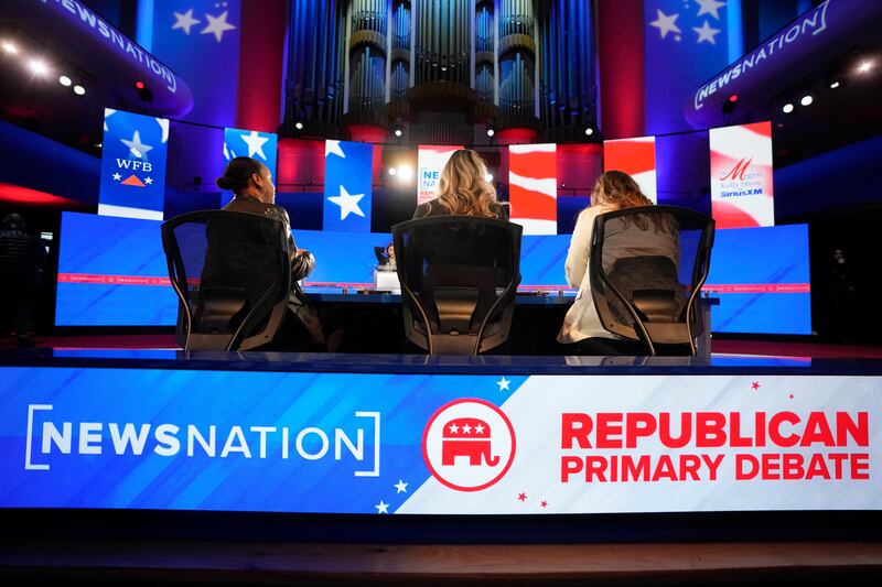Stand-ins assume positions of candidates and moderators to check sound and lighting, in advance of a Republican presidential primary debate at the University of Alabama.