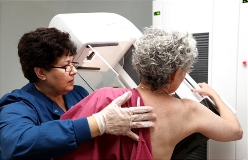 Blanca Rubio performs a mammogram on a 65-year-old patient at Evanston Hospital in Evanston, Ill., last month. Experts are debating the need for some cancer screenings for seniors.