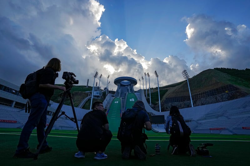 Journalists film the National Ski Jumping Centre, one of the venues for the Beijing 2022 Olympic and Paralympic Winter Games.
