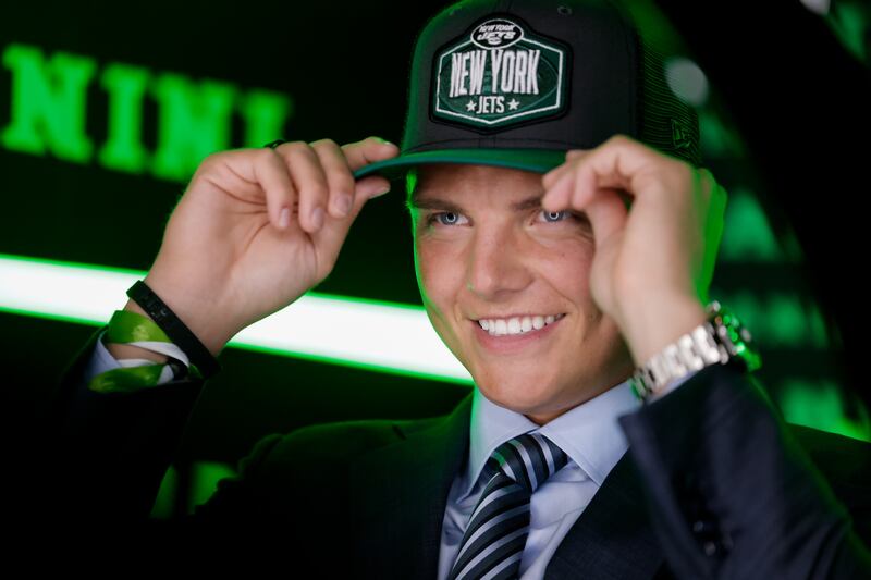 Former BYU quarterback Zach Wilson dons a New York Jets cap after being selected No. 2 overall on Thursday, April 29, 2021.