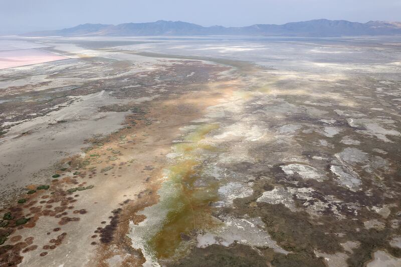 Exposed lake bed of the Great Salt Lake with mountains in the far distance.