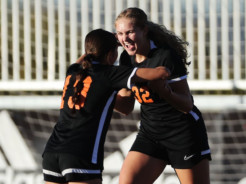 Ogden’s Ruth Larsen (wearing black) celebrates her goal with Nevaeh Peregrina