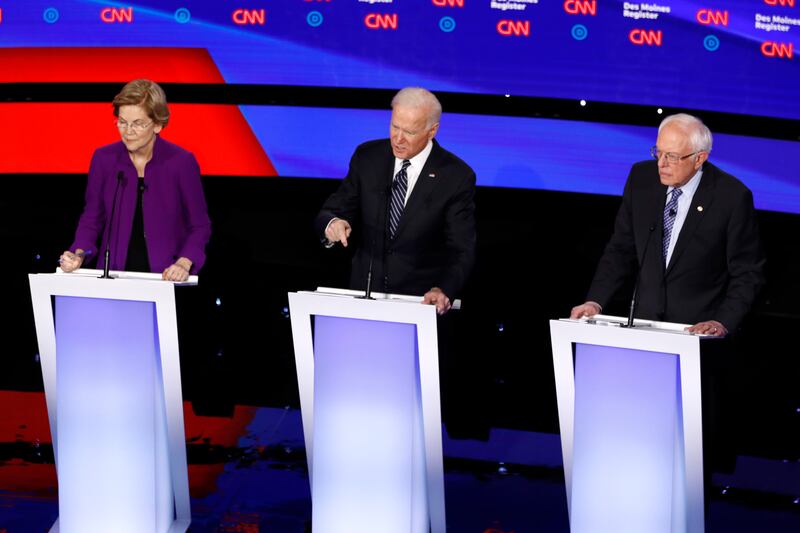 Democratic presidential candidates Sen. Elizabeth Warren, D-Mass., from left, former Vice President Joe Biden and Sen. Bernie Sanders, I-Vt., onstage, Tuesday, Jan. 14, 2020, during a Democratic presidential primary debate hosted by CNN and the Des Moines Register in Des Moines, Iowa.