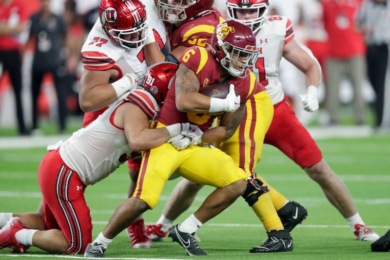 USC’s Austin Jones is tackled by Utah’s Gabe Reid during 2022 Pac-12 championship game at Allegiant Stadium in Las Vegas.