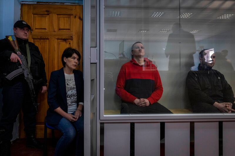 Russian soldiers Alexander Alexeevich Ivanov and Alexander Vladimirovich Bobykin attend their trial hearing in Kotelva, northeastern Ukraine.