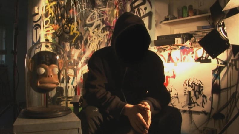 In this film publicity image released by Paranoid Pictures, graffiti artist Banksy is shown in a scene from, "Exit Through the Gift Shop." The film was nominated for an Academy Award for documentary feature, Tuesday, Jan. 25, 2011. The Oscars will be pres
