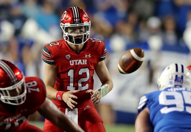 Utah quarterback Charlie Brewer takes a snap during game against BYU at LaVell Edwards Stadium in Provo on Sept. 11, 2021.