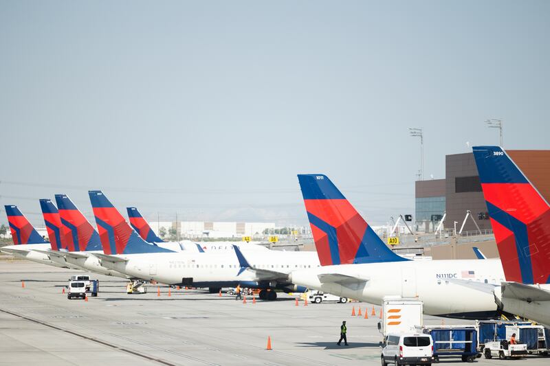 Delta Air Lines planes wait on the tarmac at the Salt Lake City International Airport.