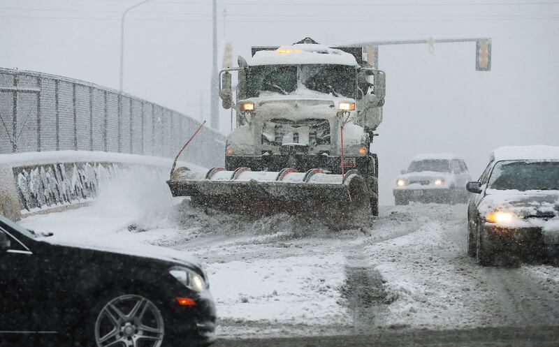 A snowplow clears the freshly fallen snow on 3300 South in Salt Lake County April 15, 2015.