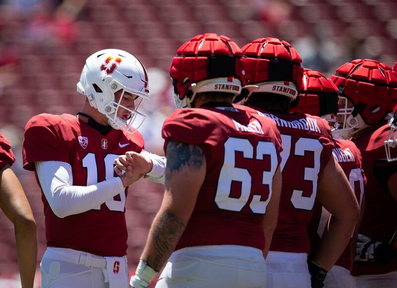 Stanford quarterback Tanner McKee calls a play in the huddle during Stanford’s spring game at Stanford Stadium.
