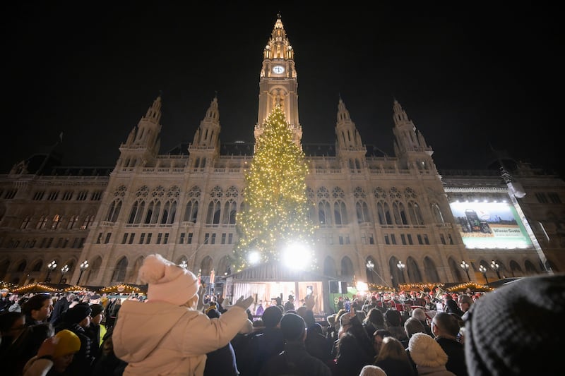 People attend the Wiener Christkindlmarkt, one of Vienna’s most popular Christmas markets in Vienna, Austria, Saturday, Nov. 19, 2022.