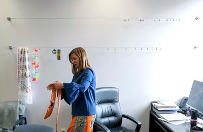 Newly elected Salt Lake County Mayor Jenny Wilson holds a tie from her predecessor, Ben McAdams, in her partially decorated office in the Salt Lake County Government Center on Thursday, March 28, 2019. McAdams helped Wilson paint the office and got paint