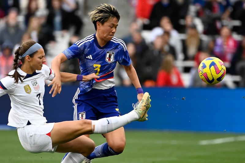 U.S. forward Ashley Hatch (7) kicks the ball away from Japan defender Moeka Minami during a SheBelieves Cup.