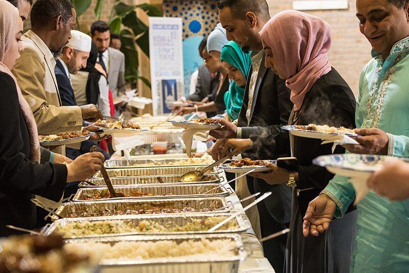People serve themselves on paper plates from a buffet during the U.S. Department of Agriculture Interfaith Iftar Celebration in Washington, D.C., on June 22, 2017.