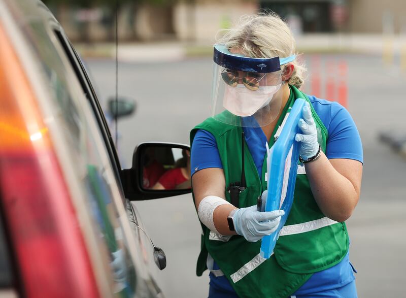 Nursing student Lia Smith helps with testing for COVID-19 conducted by the Salt Lake County Health Department in the parking lot of the Maverik Center in West Valley City on Sunday, Aug. 23, 2020. The free testing was set up for residents of Kearns, Magna, Taylorsville, West Valley City or the west side of Salt Lake City.
