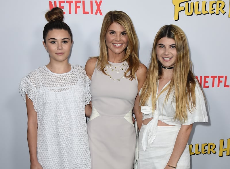Lori Loughlin, center, and her daughters Olivia Jade Giannulli and Isabella Rose Giannulli attend the premiere of “Fuller House” on Feb. 16, 2016, in Los Angeles.