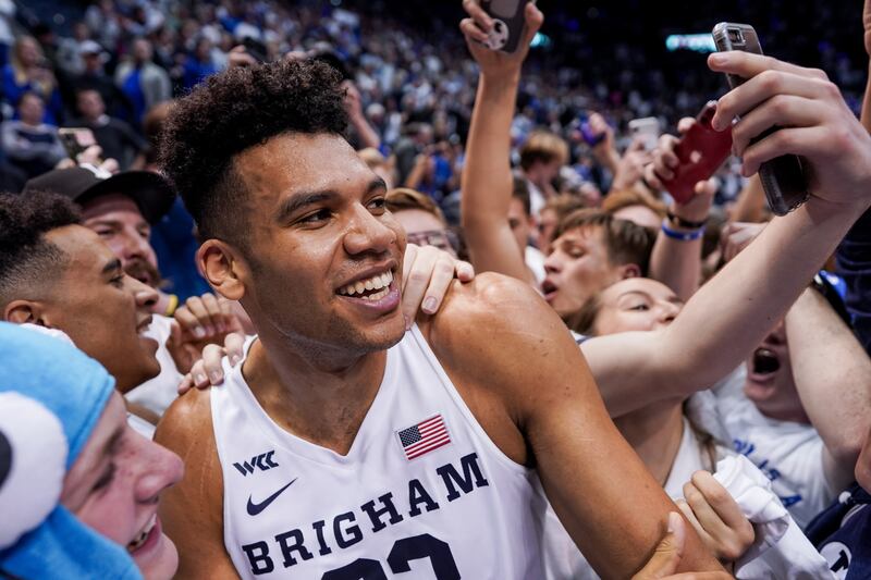 Brigham Young Cougars forward Yoeli Childs (23) celebrates with fans who rushed the court after BYU toppled No. 2-ranked Gonzaga
