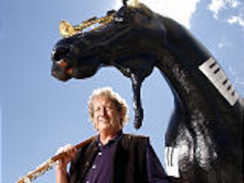 Sculptor Bill Kranstover shows off "Moosic," his moose-terpiece with 25 band instruments.