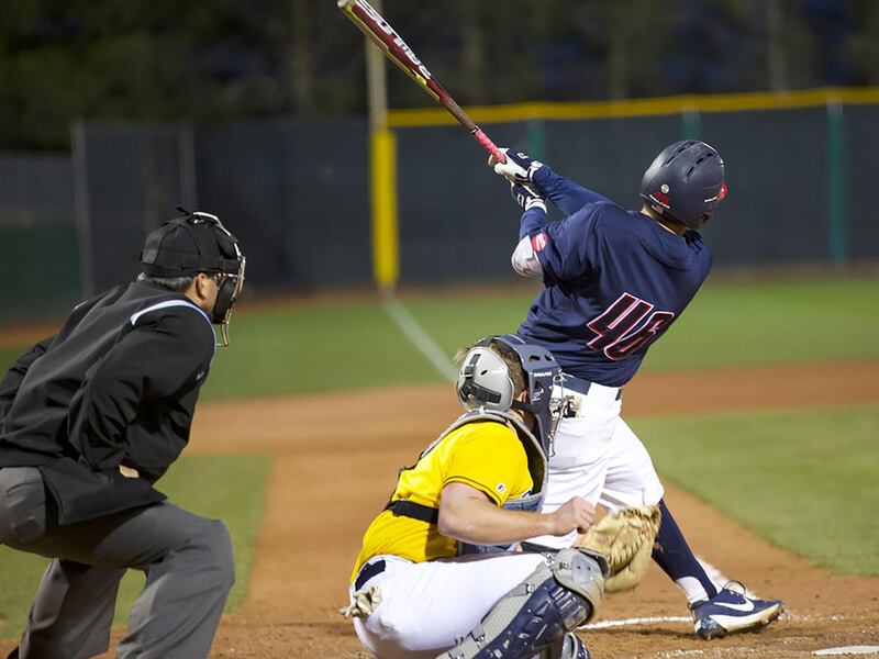 Dixie State junior 1B Logan Porter (right) hits the ball. He went a combined 6-for-6 with six RBIs in a Sunday PacWest DH sweep of Holy Names at Bruce Hurst Field.