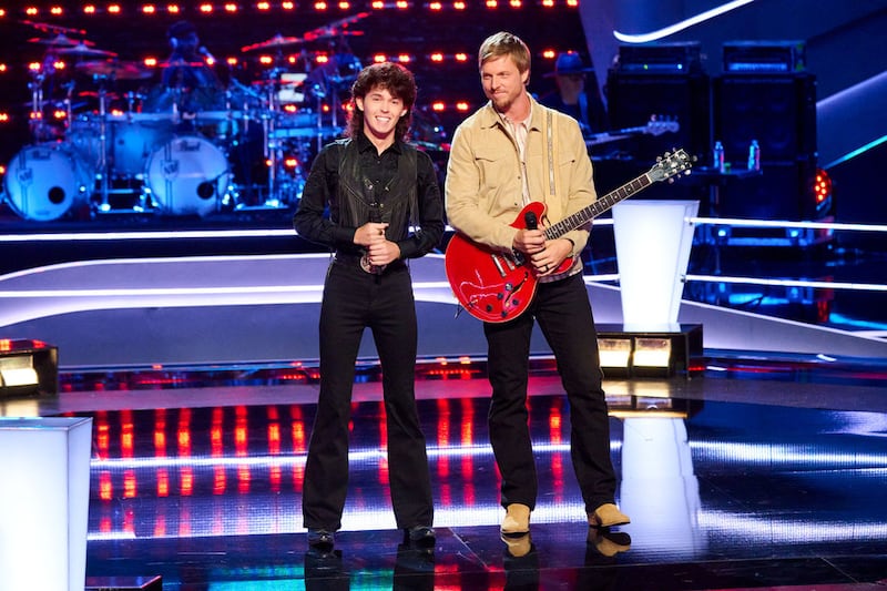 Brayden Howell, left, and Cade Mower stand together on "The Voice" stage following their performance during the Battle round. Mower, a singer from Utah, advanced to the next round of the competition.
