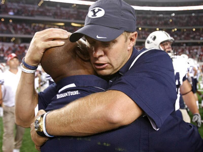 BYU head coach Bronco Mendenhall, right, hugs defensive coordinator Jaime Hill after the Cougars and their tough defense toppled Oklahoma at the new Cowboys Stadium.