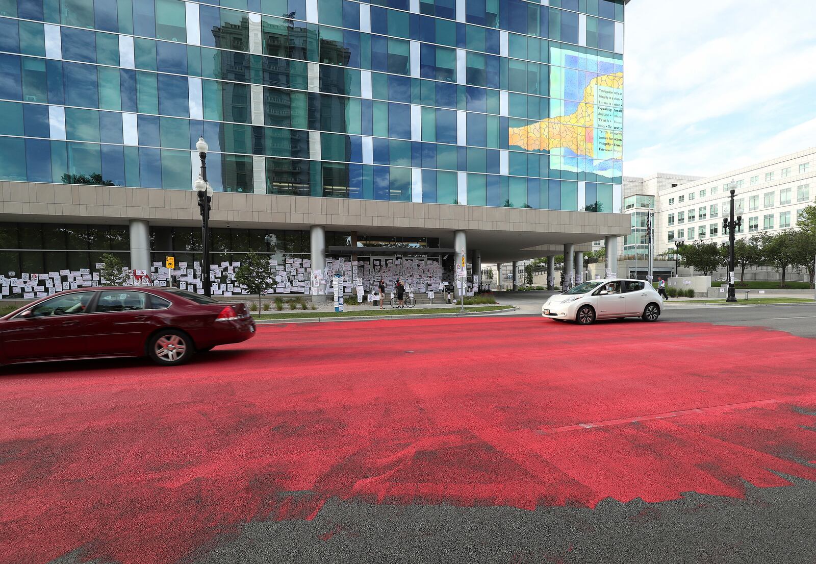 Family and friends of Bernardo Palacios-Carbajal painted the street red in protest in front of the Salt Lake County District Attorney’s Office in Salt Lake City.
